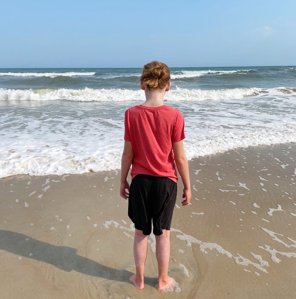 boy on beach looking at ocean | having an immunocompromised child